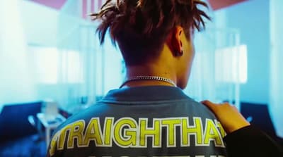 a man with dreadlocks standing in a room