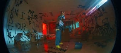 a man standing in a room covered in graffiti