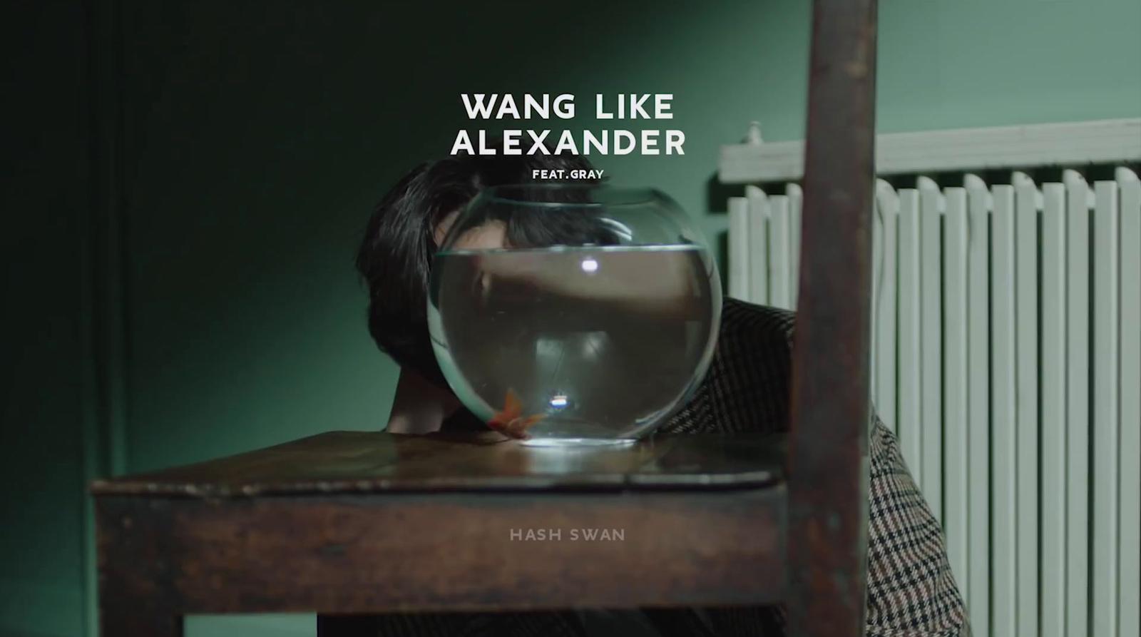 a person sitting at a table with a fish bowl on top of it
