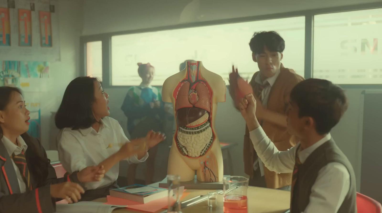 a group of people standing around a mannequin