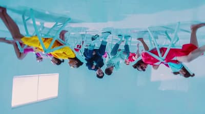 a group of people hanging upside down in a pool