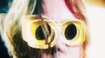 a close up of a cat's face with yellow glasses