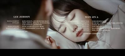 a woman sleeping in bed with her eyes closed