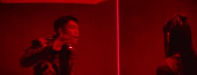 a man standing in front of a red light