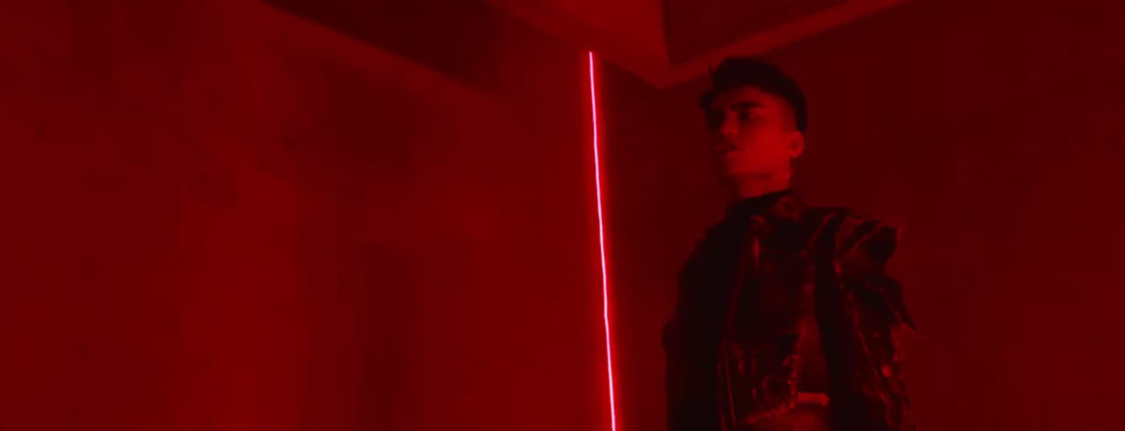 a man standing in front of a red light
