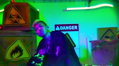 a man standing in a room with neon lights