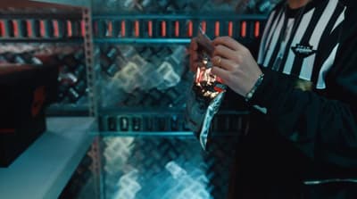 a person holding a cell phone in a store