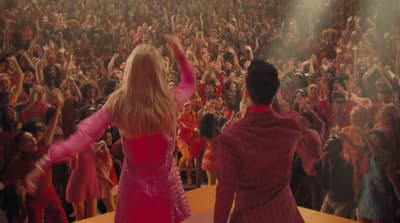 a couple of people that are standing in front of a crowd
