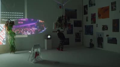 a man standing in front of a projection screen