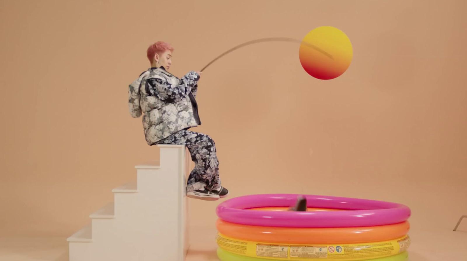 a man is balancing a ball on top of a set of stairs