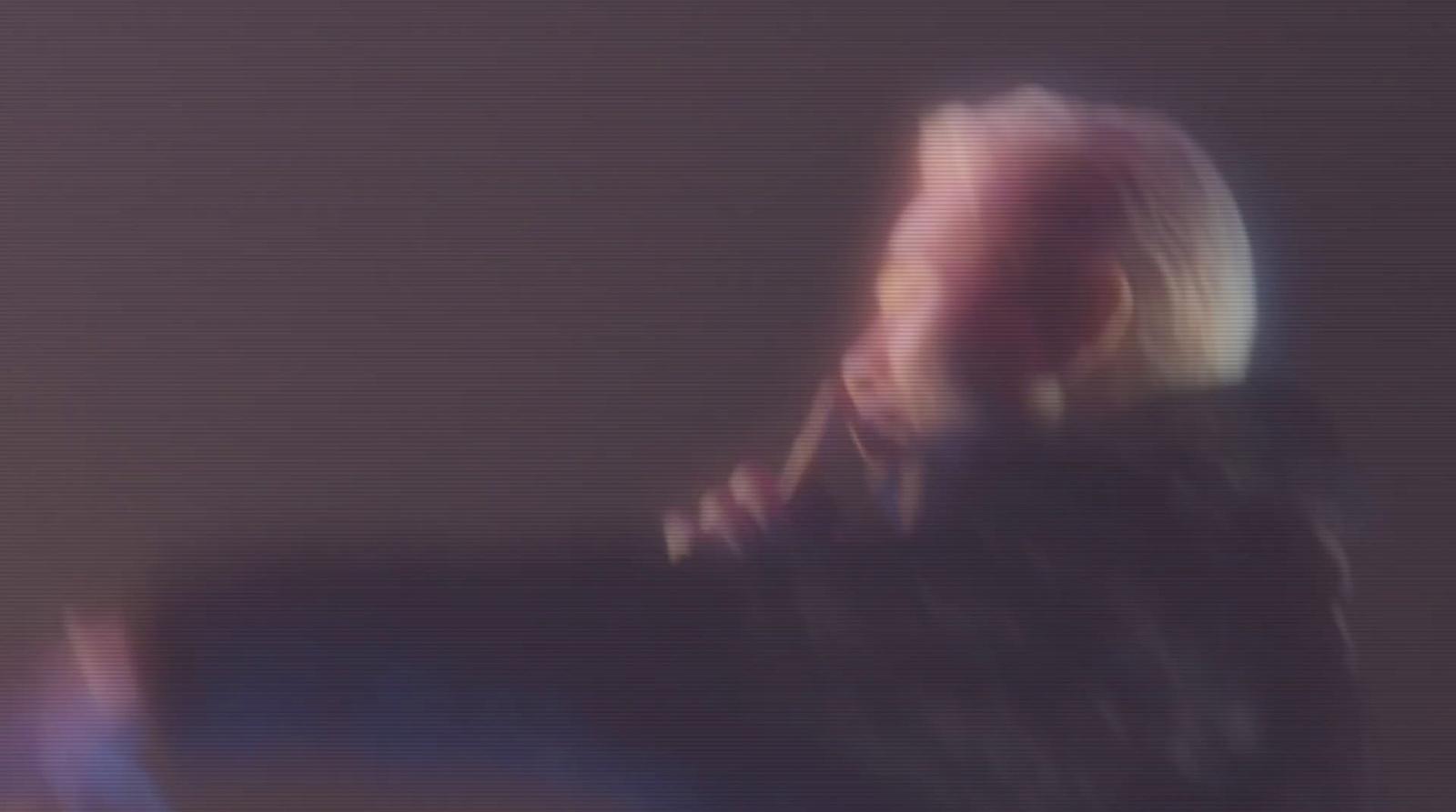 a blurry photo of a person sitting down