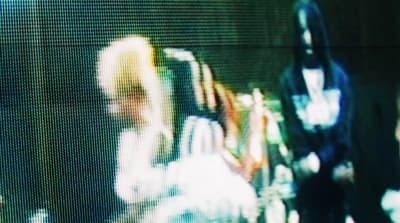 a blurry image of a woman sitting in a chair