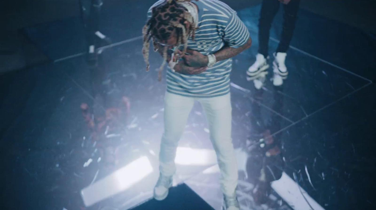 a man with dreadlocks standing on a stage