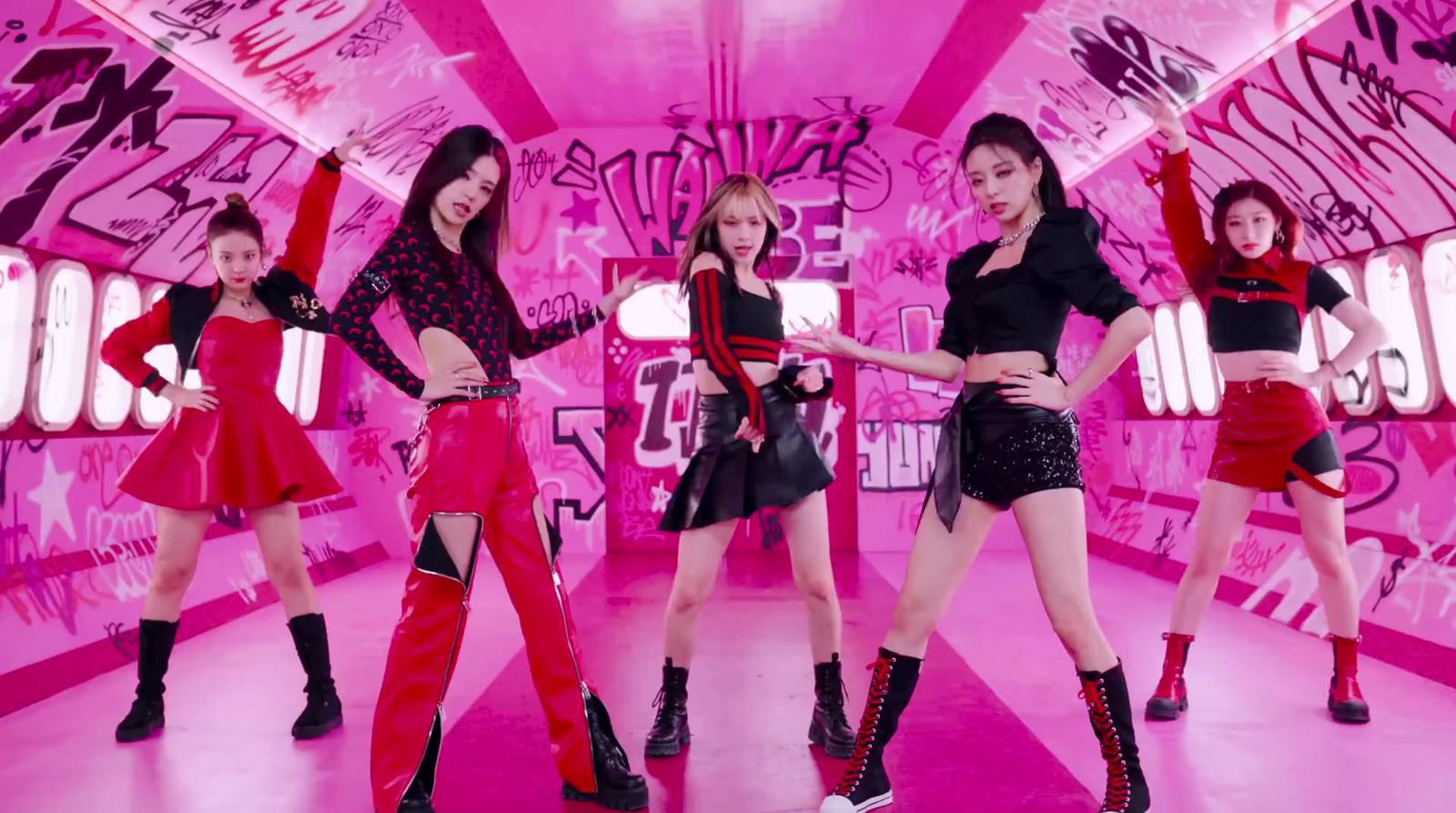 a group of young women dancing in a pink room