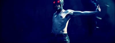 a shirtless man with a knife in his hand