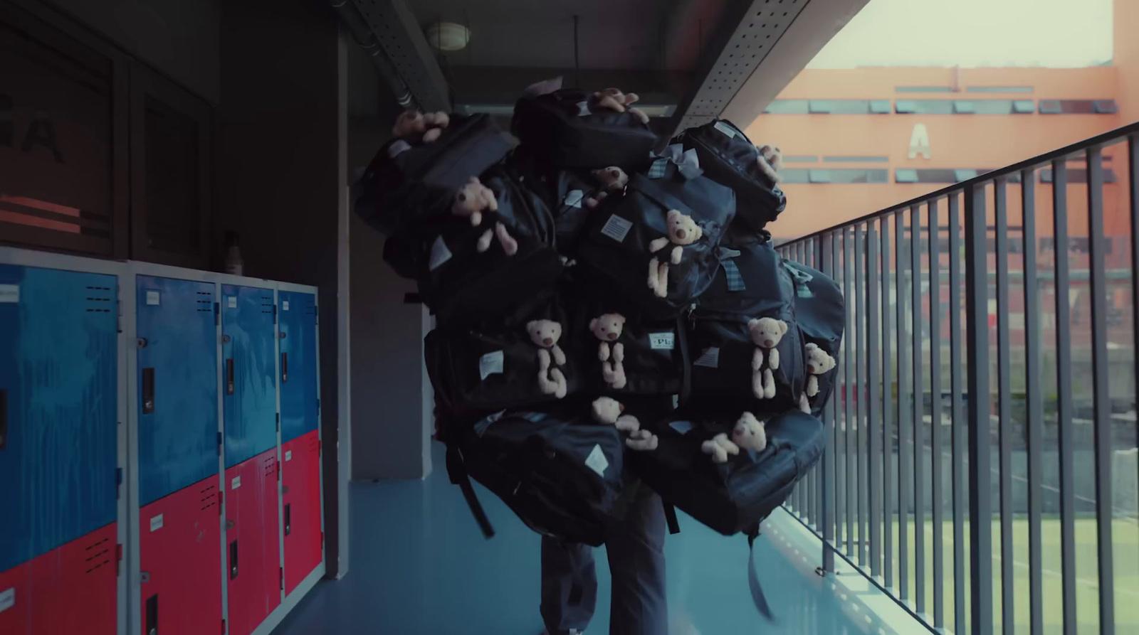 a man carrying a large amount of stuffed animals on his back