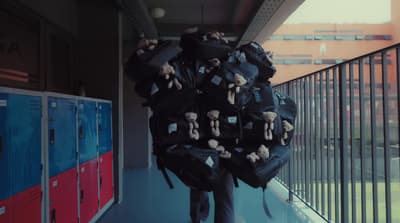 a man carrying a large amount of stuffed animals on his back