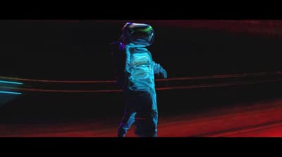 a man in a space suit standing in the dark