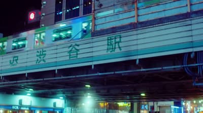a train traveling over a bridge at night