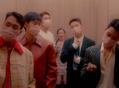 a group of people standing next to each other wearing face masks