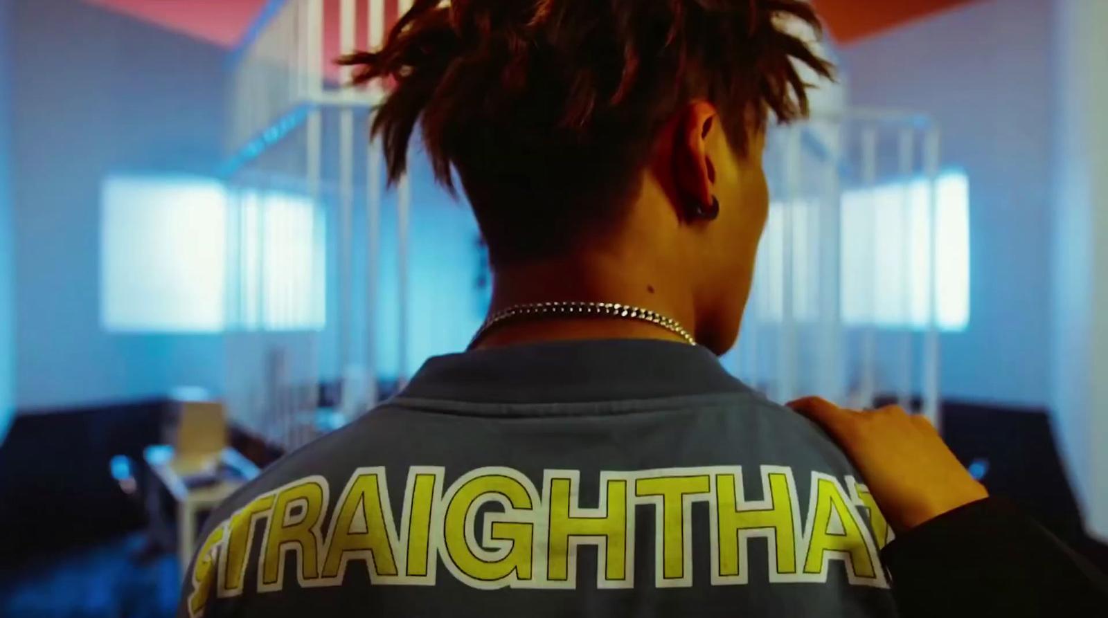 a person with dreadlocks standing in a room