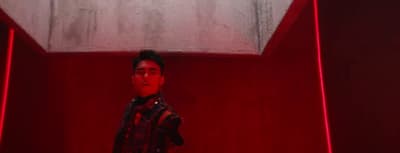 a man standing in front of a red light
