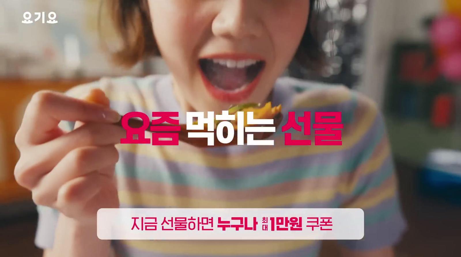 a woman holding a piece of food in her hand