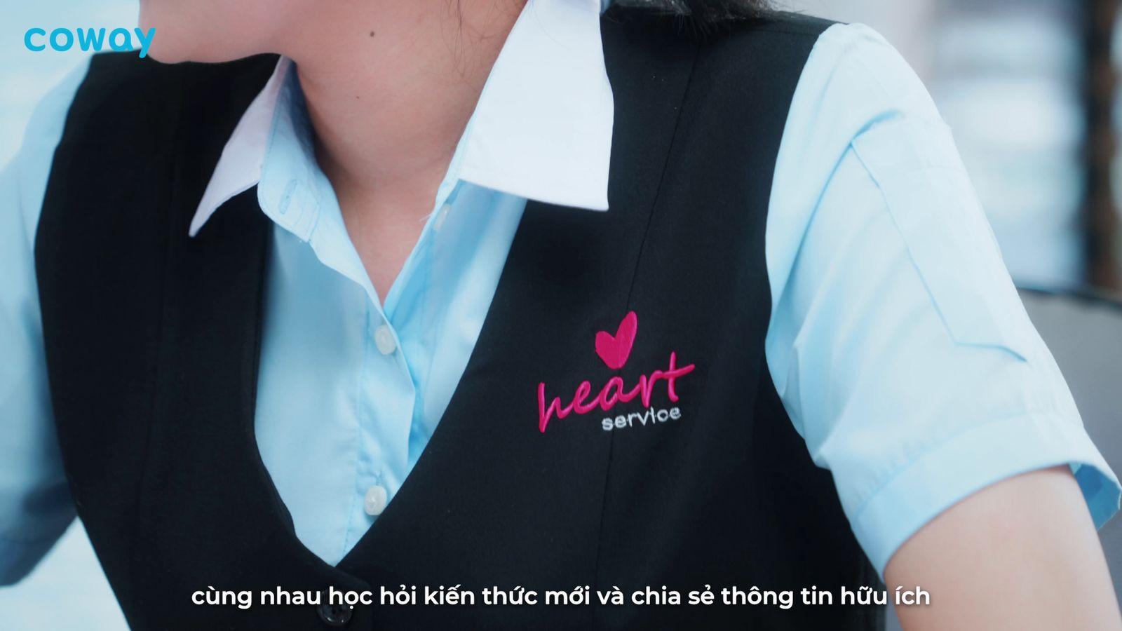 a woman wearing a black vest and a blue shirt
