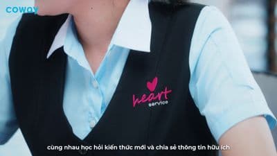 a woman wearing a black vest and a blue shirt