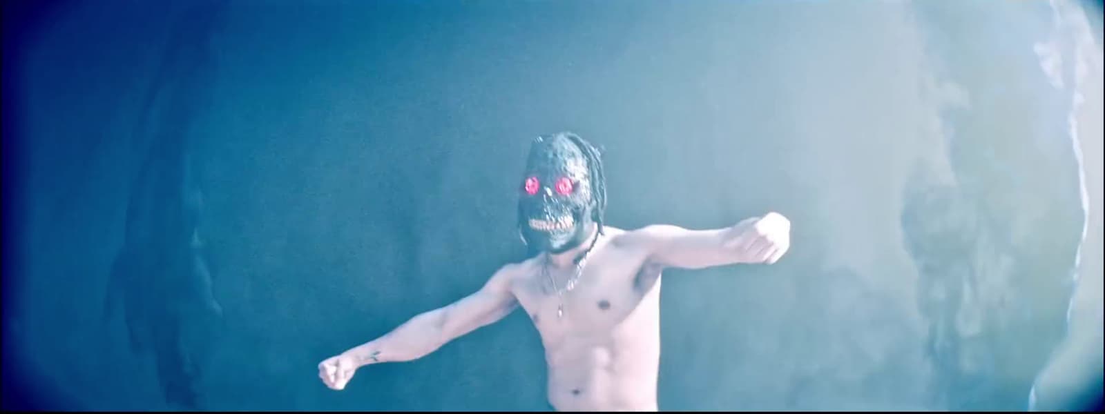 a man wearing a mask and holding a tennis racquet