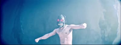 a man wearing a mask and holding a tennis racquet