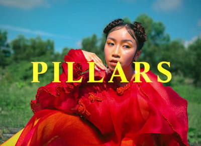 a woman in a red dress with the words pillars in front of her