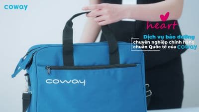 a woman holding a blue bag with a black handle