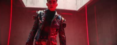a man in a red and black outfit standing in a room