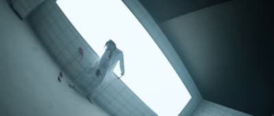 a person standing in a room with a skylight