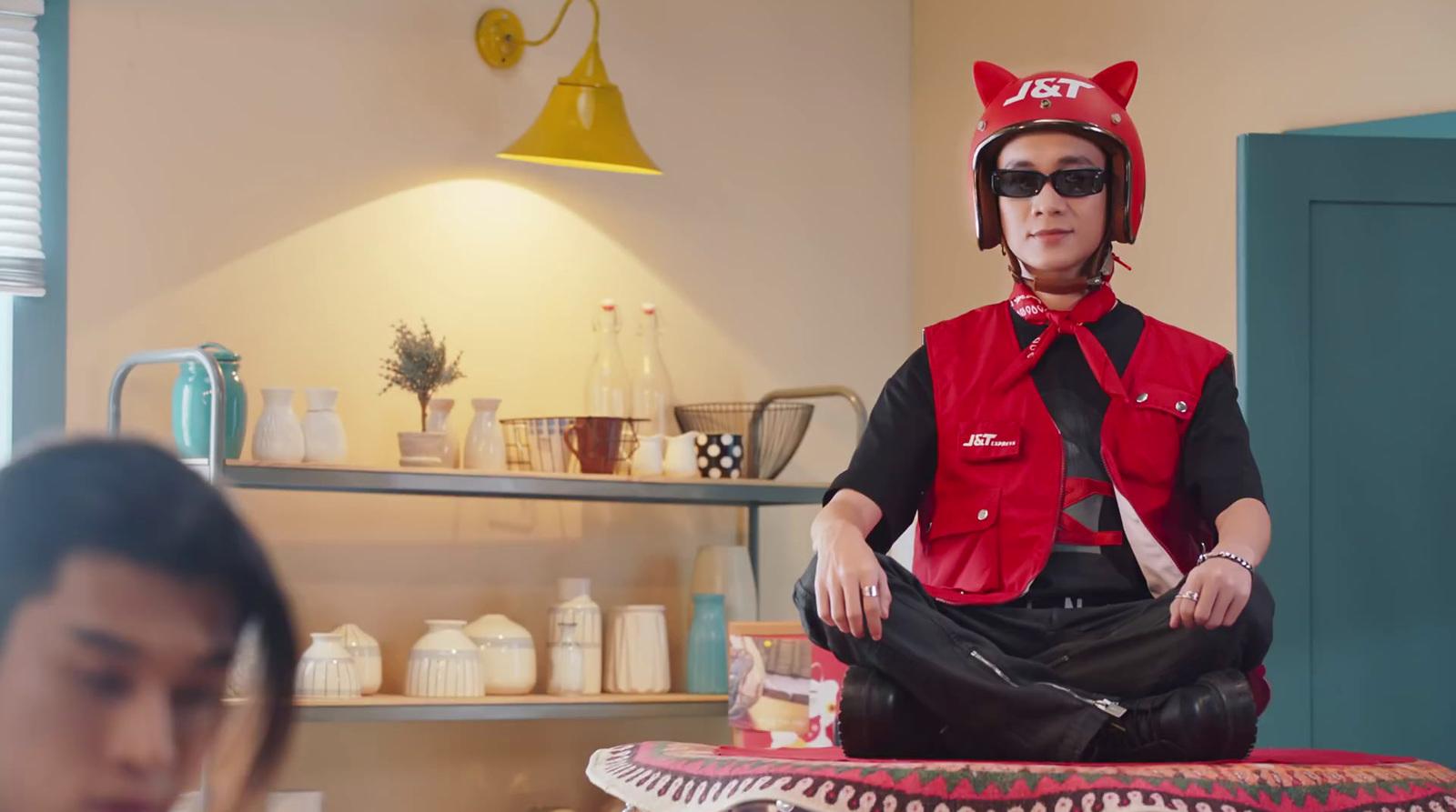 a woman sitting on a stool with a cat hat on