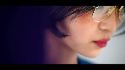 a close up of a person wearing glasses