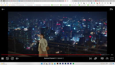 a person standing on a balcony overlooking a city at night