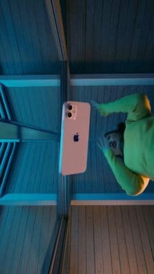 a man standing next to an iphone in a room