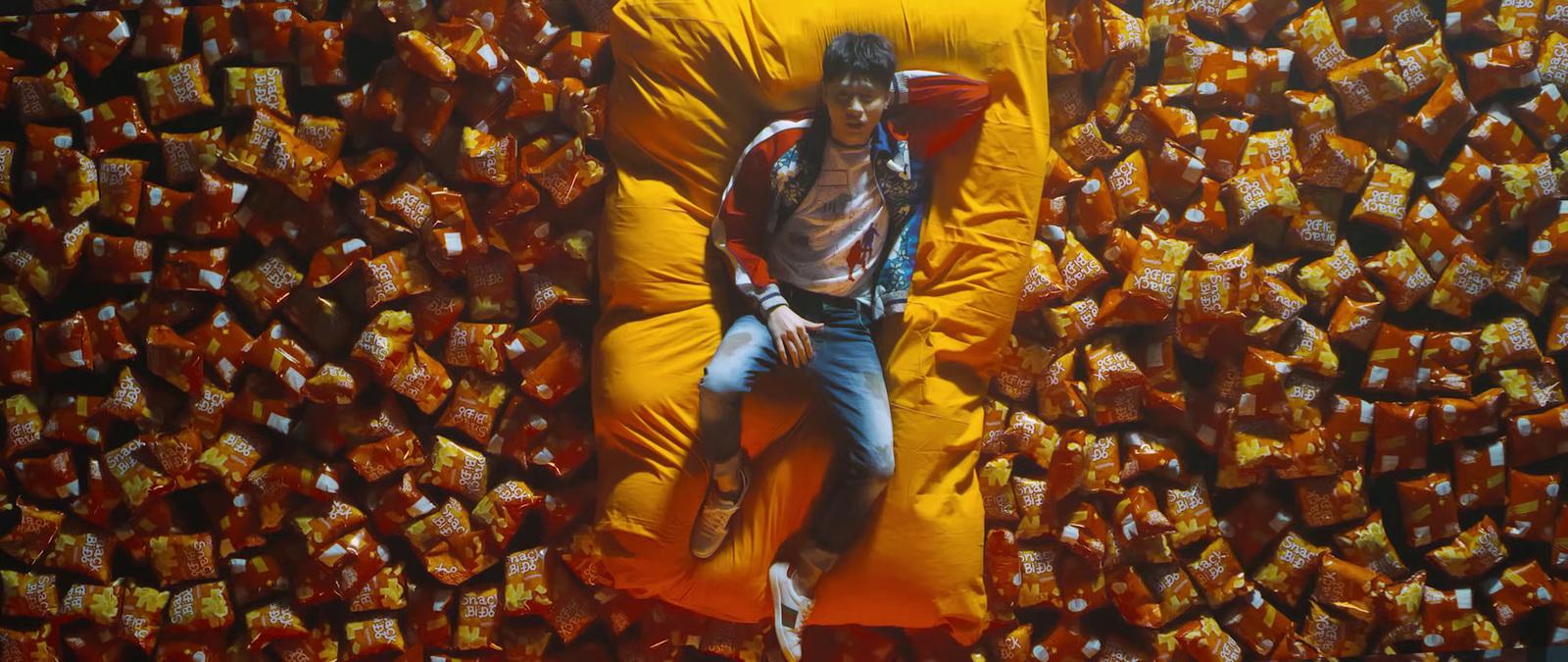 a man laying on top of a giant yellow pillow