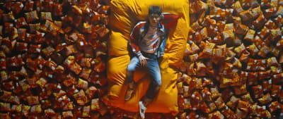 a man laying on top of a giant yellow pillow