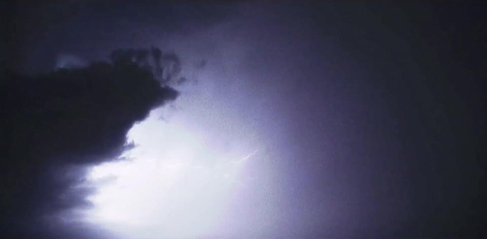 a large cloud with a lightning bolt coming out of it