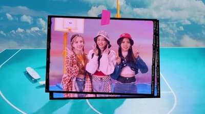 a group of girls standing on top of a basketball court