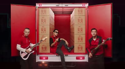 a group of men standing next to each other in front of a truck