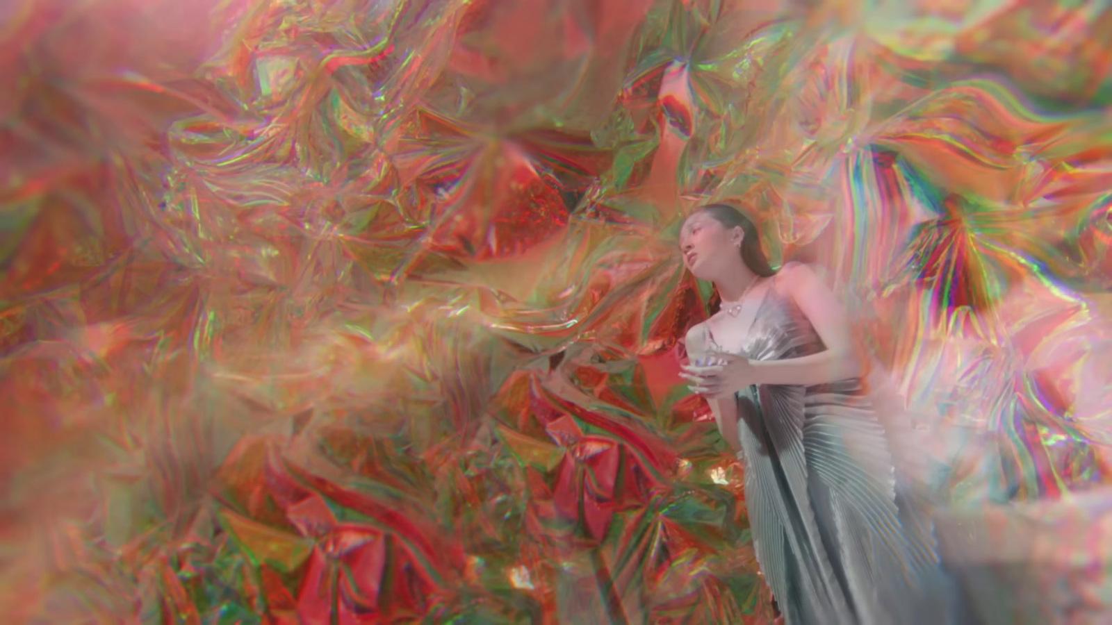 a woman standing in front of a colorful background