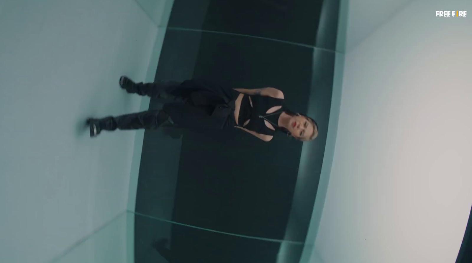 a woman in a black dress standing in a room