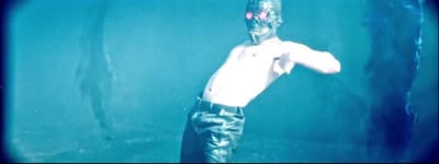 a shirtless man standing in the water