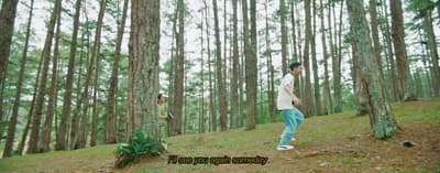 a man standing in the middle of a forest