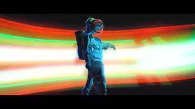 a man standing in front of a colorful light