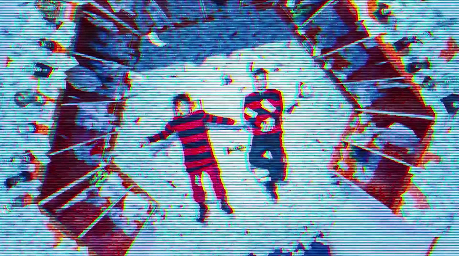 a couple of people standing on top of a snow covered slope